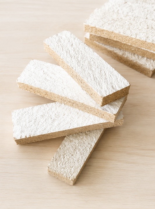 Mycelium composite tile samples with white growth surface and fibrous core
